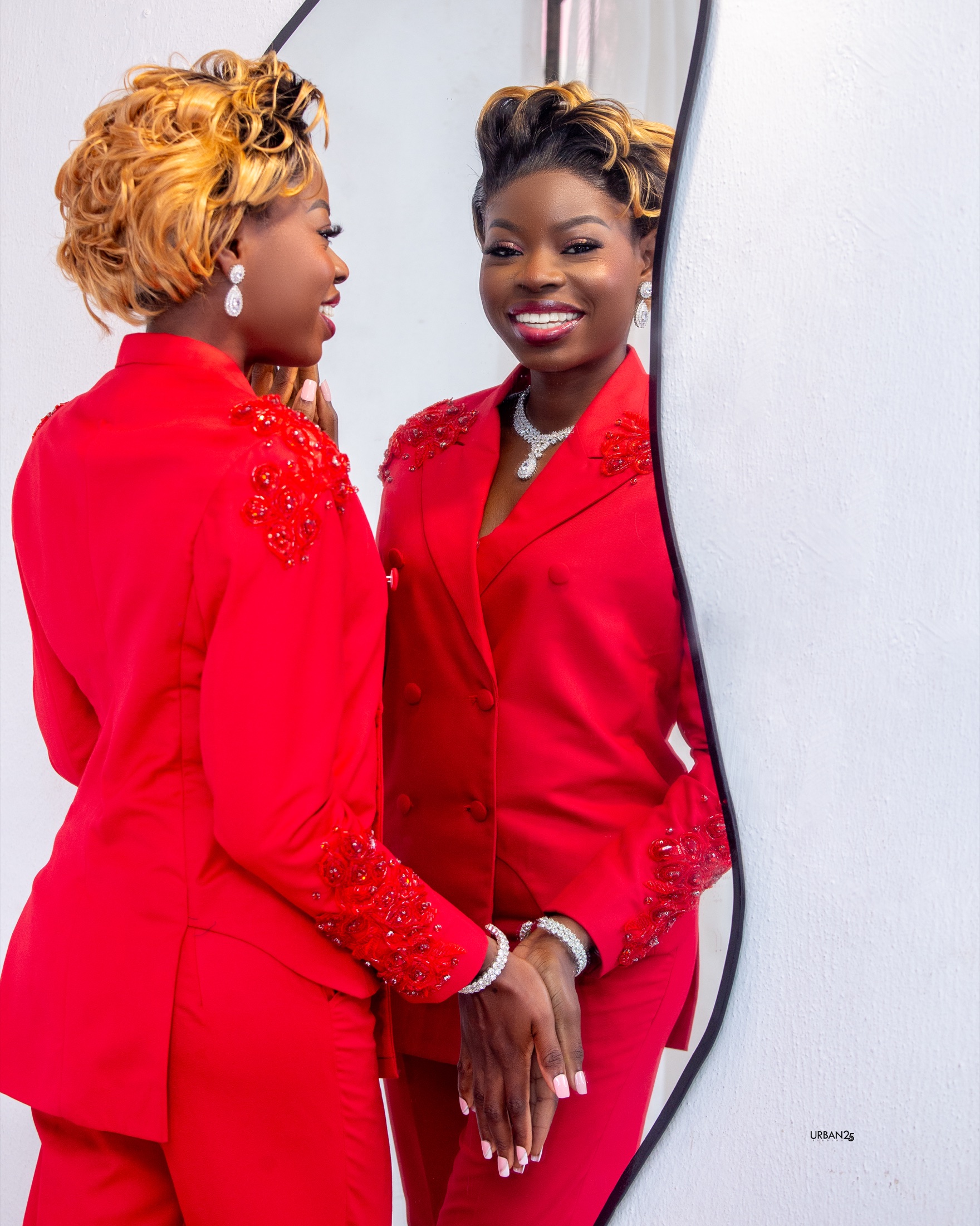 Lady Ife smiling in a mirror